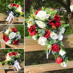 A teardrop bouquet collection of white and red roses and anenomies